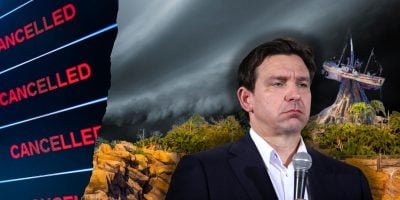 A man stands holding a microphone with a serious expression. Behind him, there's a stormy sky and a theme park ride shaped like a sinking ship. To the left, there's a backdrop displaying the word "CANCELLED" repeatedly in red text, reminiscent of unsettling times at Florida's Disney Park.