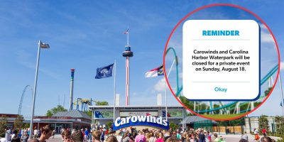 A crowd of people stand in front of the entrance sign of Carowinds amusement park. A reminder notice in the image states that Carowinds and Carolina Harbor Waterpark will be closed for a private event on Sunday, August 18.