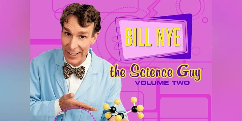 The image showcases a promotional poster for "Bill Nye the Science Guy Volume Two." Bill Nye, wearing a light blue lab coat and colorful bow tie, smiles while holding a molecular model. The pink background features geometric shapes and a purple sign with the title prominently displayed.