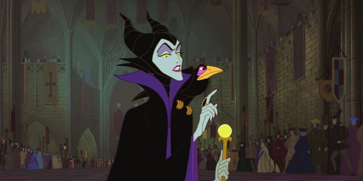 An animated character with green skin, horns, and a black robe stands in a grand hall. She holds a staff topped with a glowing yellow orb. A black raven perches on her shoulder. The background shows a crowd of people and a large, ornate medieval-style room.