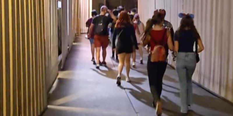 People walking in a backstage area at Disneyland Park behind Main Street, U.S.A.