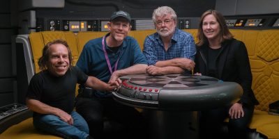 Kathleen Kennedy sits with Warwick Davis, Ron Howard, and George Lucas.