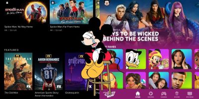 A split-screen image showing two streaming platforms. Mickey Mouse sits crying in between.