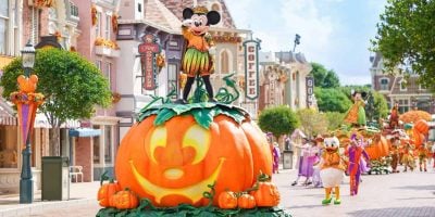 Mickey Mouse stands on top of a pumpkin in a Halloween parade at Hong Kong Disneyland