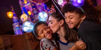 A family in front of Cinderella Castle during a Disney After Hours event at Magic Kingdom