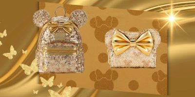A shimmering gold-themed display featuring a sparkly sequined backpack and a matching crossbody bag. Both are adorned with large gold bows, and the backpack has additional Mickey Mouse ears. The Auto-Draft background showcases a similar glittery gold design with butterflies and bows.