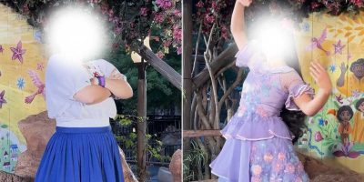 Two people pose in front of a colorful backdrop featuring trees, flowers, and characters from Encanto. The person on the left crosses their arms and wears a white shirt and blue skirt. The person on the right gestures expressively in a light purple dress. Faces are blurred.