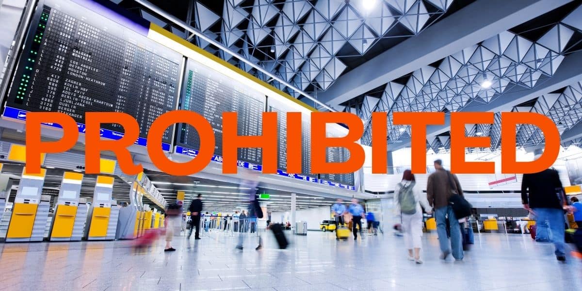 An airport terminal with the word "prohibited" over the top