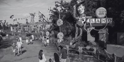 A black and white picture of people walking into Toy Story Land at Disney's Hollywood Studios.