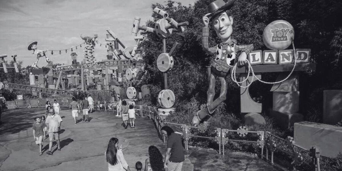 A black and white picture of people walking into Toy Story Land at Disney's Hollywood Studios.