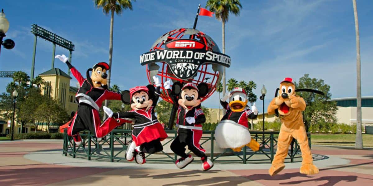 Goofy, Minnie Mouse, Mickey Mouse, Donald Duck, and Pluto jump in front of the Wide World of Sports Sign