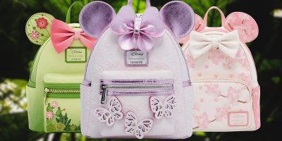 Three enchanting Minnie Mouse Loungefly Backpacks are showcased. The green version, adorned with floral designs and ears, sits beside the lavender one, featuring butterflies and a pink bow. Completing the trio is a charming pink backpack with white polka dots and bows. Available for pre-order at BoxLunch.