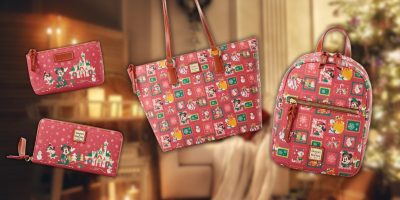 A collection of Disney-themed accessories featuring a wristlet, wallet, tote bag, and backpack adorned with colorful Mickey Mouse cartoon designs. The background includes a cozy, softly lit room with a decorated Christmas tree, evoking the warmth of a family Christmas.
