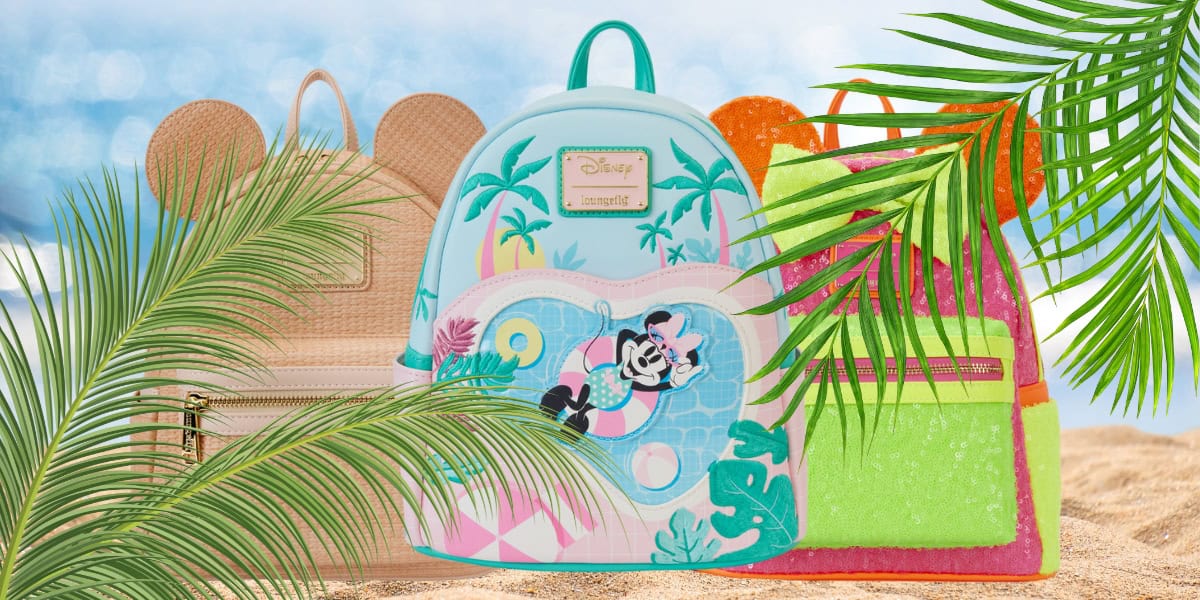 Three colorful Disney Loungefly backpacks with tropical designs featuring palm leaves and iconic characters sit prettily on a sandy beach. The backdrop showcases a bright sky and ocean waves, framed by lush green palm fronds, perfectly capturing those summer vibes.