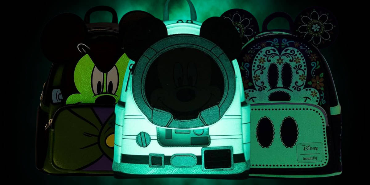 Three glow-in-the-dark Loungefly backpacks featuring cartoon character designs: the first has a grumpy face, the second resembles an astronaut suit, and the third has decorative floral patterns. All bags are brightly illuminated against a dark background, making them perfect for avid Disney collectors.