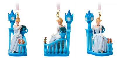 Three views of a blue Cinderella ornament capture her as a Disney Princess in a white dress, sitting on a castle balcony with a clock tower. She interacts with small mice figures beside a pumpkin, making this piece a must-have collectible for fans of enchanted stories.