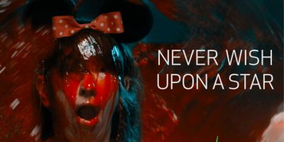 A girl wearing a Minnie Mouse headband is drenched in blood. The text reads "Never Wish Upon a Star"