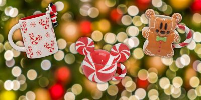 Festive decorations for the holiday season include a mug with red candy cane patterns, a charming Mickey-shaped dish with red and white swirls, and a gingerbread man mug featuring a striped handle. Blurred holiday lights fill the background, enhancing the magical Disney vibe.