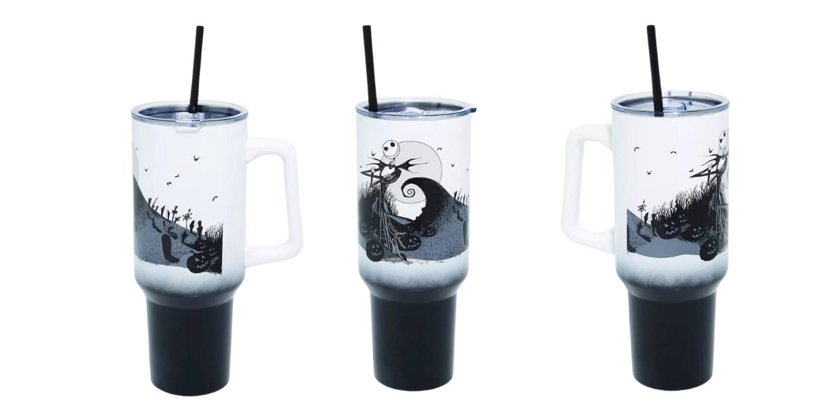 Three stainless steel travel cups with handles are shown, each featuring a black and white design inspired by a whimsical, dark fantasy theme. Two have Jack Skellington standing on a hill against a moonlit sky, while the third has bats. Each includes a black straw.