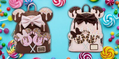 Two colorful backpacks resembling Minnie Mouse ears delight Disney fans with their candy and chocolate themes. One, in brown with a pink bow, and the other, beige with a brown bow, are accented by lollipop ears amidst an array of candies on a blue backdrop.