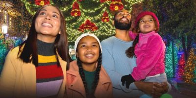 Family of four in front of the Christmas lights at Dollywood