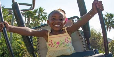 A young girl rides Pteranodon Flyers at Universal Orlando Resort