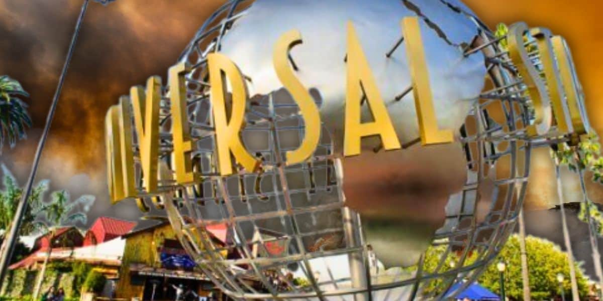 A large metallic globe with the word "Universal" in bold, golden letters is prominently displayed. The background features palm trees and a dramatic sky with orange and brown clouds, capturing the iconic essence of Universal Studios as it prepares to reopen its doors.