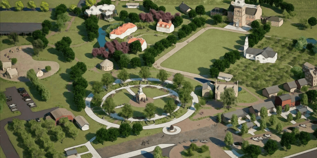 Aerial view of a park with a circular pathway. Surrounding the pathway are trees and various buildings, including a church with a tall steeple, residential houses with red roofs, and a white pavilion. Pathways connect different areas.
