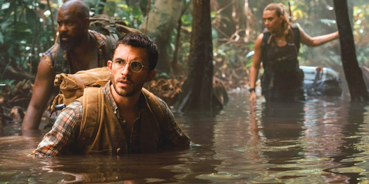 Jonathan Bailey, and Scarlett Johansson wading through a swamp in 'Jurassic World Rebirth'