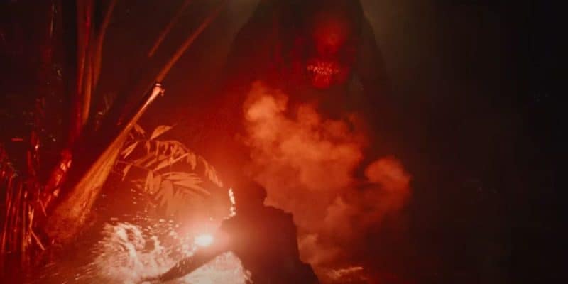 Mahershala Ali holding a red flare to the new mutant dinosaur in the 'Jurassic World Rebirth' trailer
