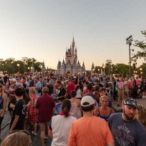 A large crowd in Magic Kingdom with Cinderella Castle in the background at Disney World