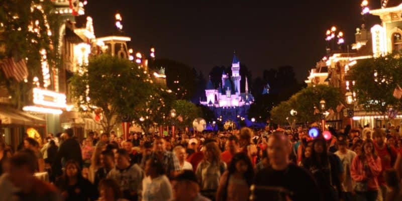 Crowds on Disneyland Park's Main Street, U.S.A., at night.