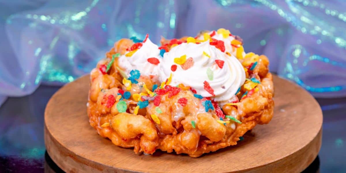 A funnel cake with rainbow cereal on it.