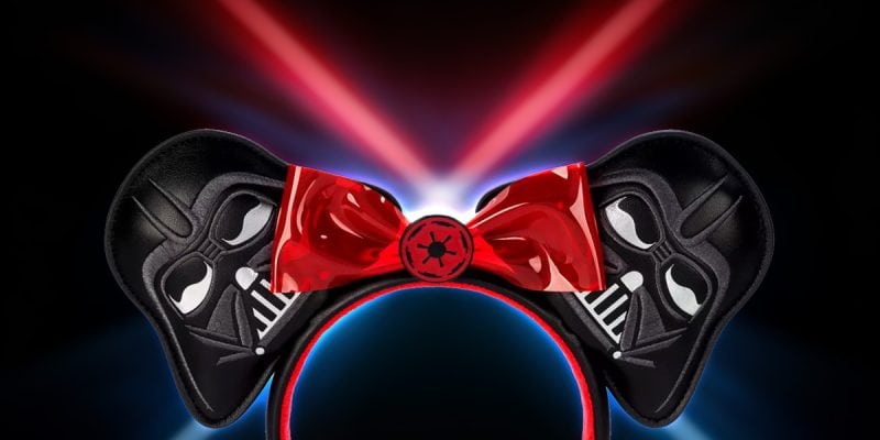 A Dark Side ear headband featuring Darth Vader-themed ears and a striking red bow.