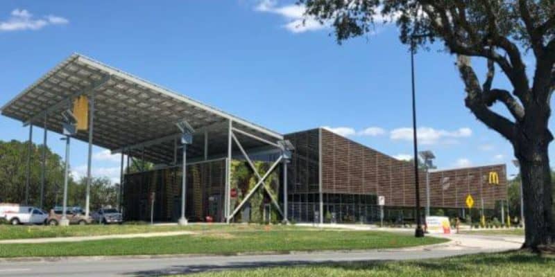 A modern McDonald’s building with a large solar panel roof at Walt Disney World Resort.