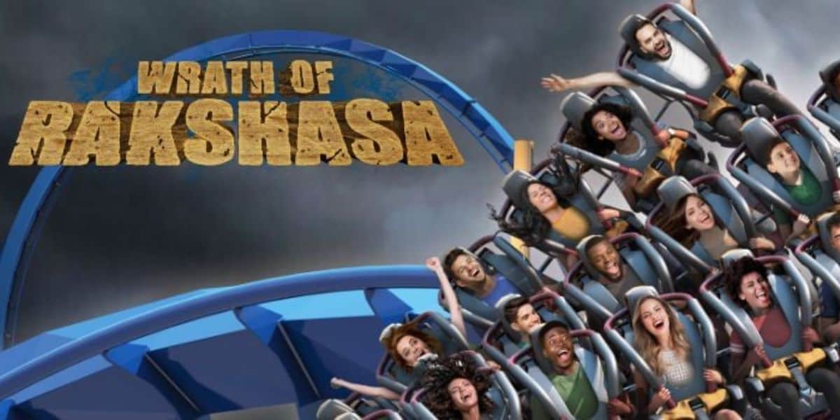 A roller coaster labeled "Wrath of Rakshasa" speeds down a blue track at Six Flags Great America.