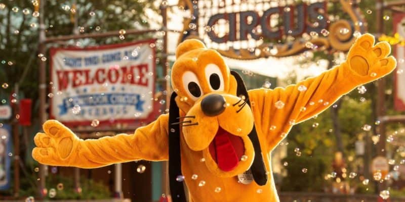Pluto stands in front of Storybook Circus at the Magic Kingdom