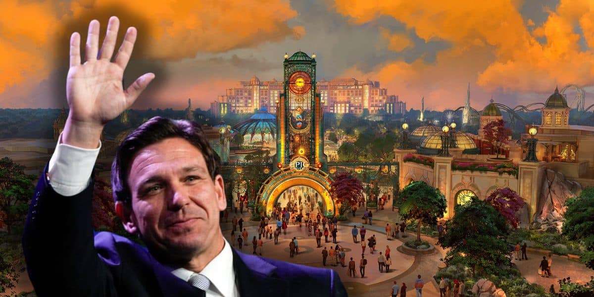 Florida Governor Ron DeSantis waves in the foreground, with a fantasy-style theme park entrance and groups of people in the background under a dramatic orange sky inside of Universal Epic Universe.