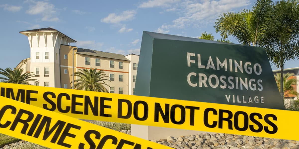 Yellow "CRIME SCENE DO NOT CROSS" tape blocks the entrance to Flamingo Crossings Village following a shooting, with palm trees and a multi-story building visible in the background on a sunny day.