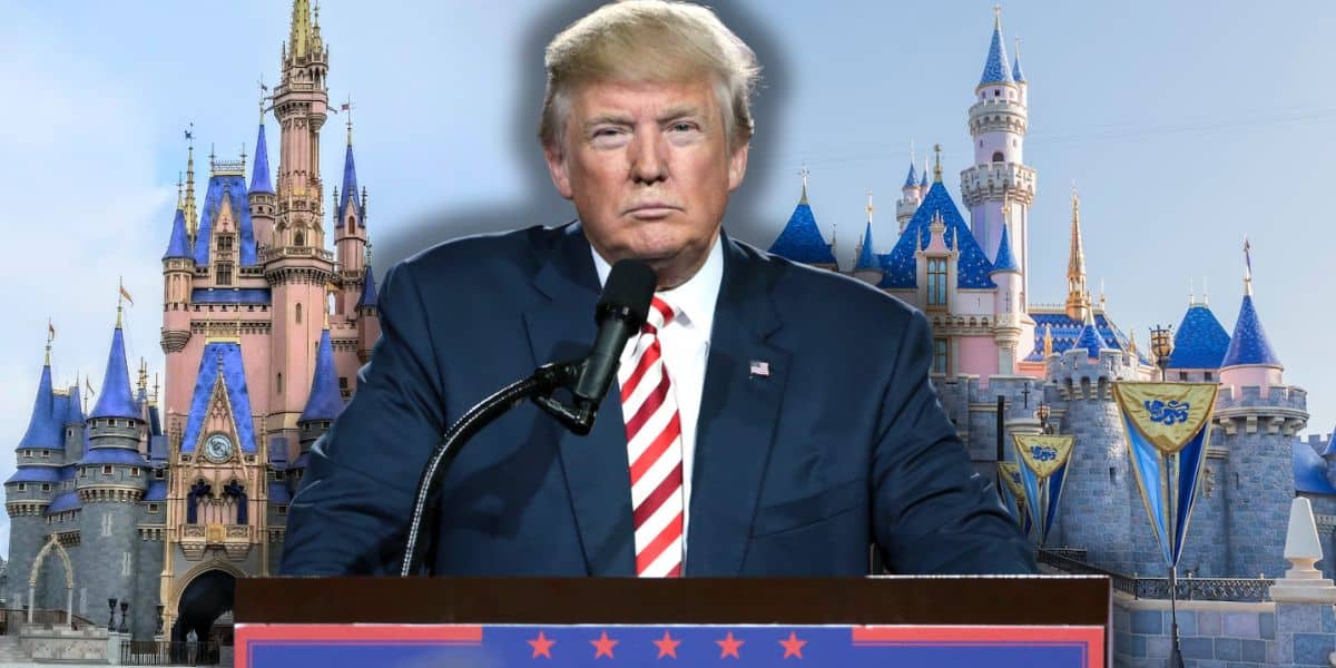 President Donald Trump in a suit and striped tie stands at a podium with microphones in front of Cinderella Castle and Sleeping Beauty Castle