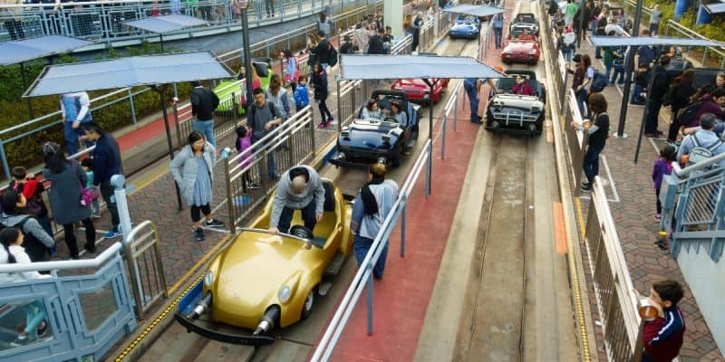 Guests queue and board cars at Disneyland Resort's Autopia attraction