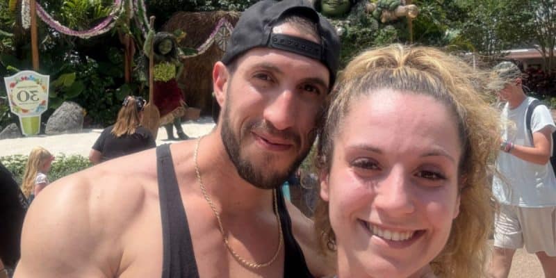 A man and a woman, both smiling. The woman is wearing a sports bra that violated the Disney Dress code.
