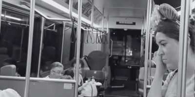 A black and white photo of people in a Disney World bus after a minor accident.