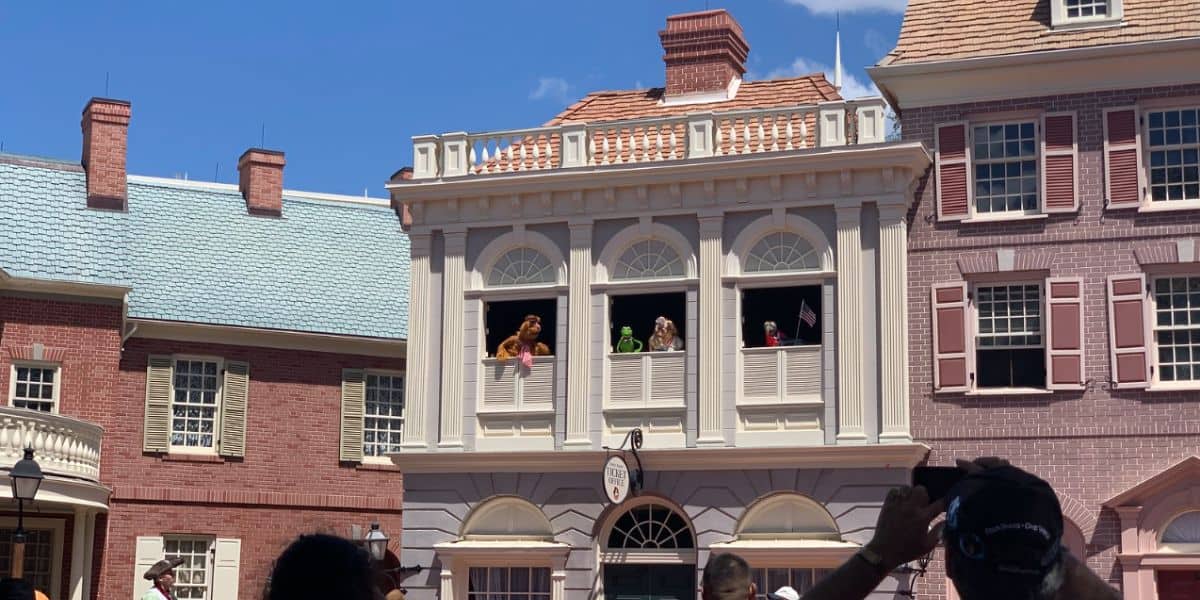 Three beloved Muppets characters, including Kermit the Frog, Miss Piggy, and Fozzie Bear, perform from the second-story windows of Liberty Square.