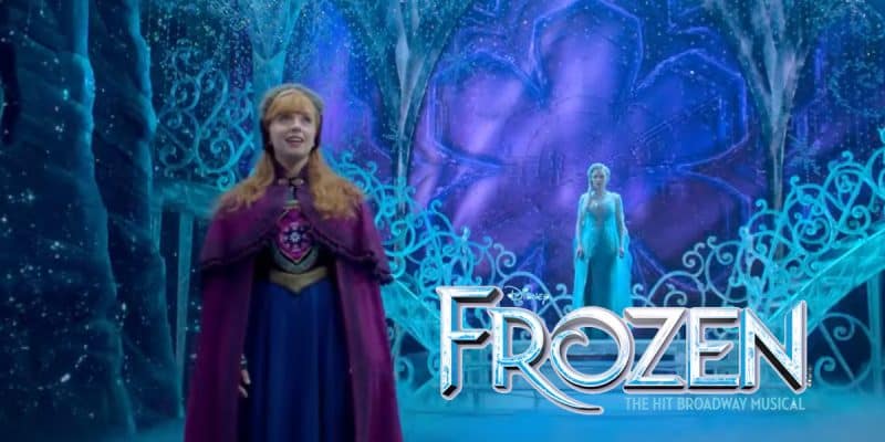 Two women in elaborate costumes stand on stage with icy blue, sparkling set pieces behind them. The text reads, "Frozen The Broadway Musical." This dazzling Broadway show evokes a magical, wintery atmosphere.