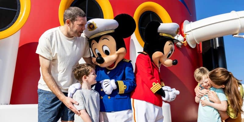 Two children and two adults with Mickey and Minnie on a Disney Cruise ship