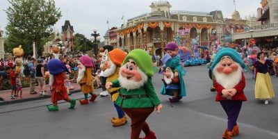 Snow White and the Seven Dwarfs in a parade at Magic Kingdom Park.