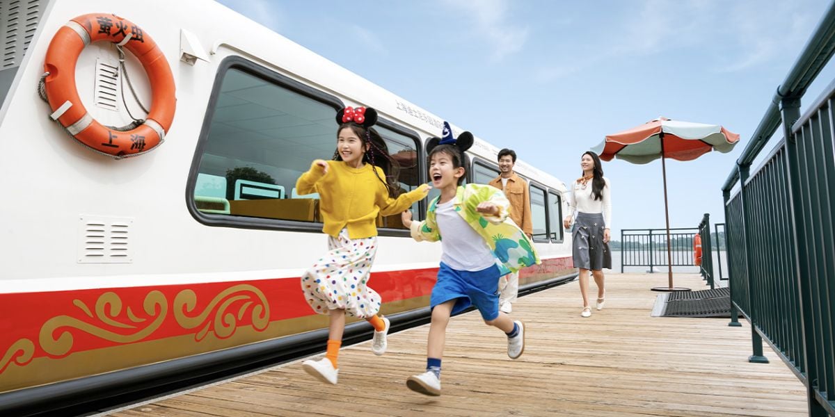 Young guests run past a boat at Shanghai Disneyland