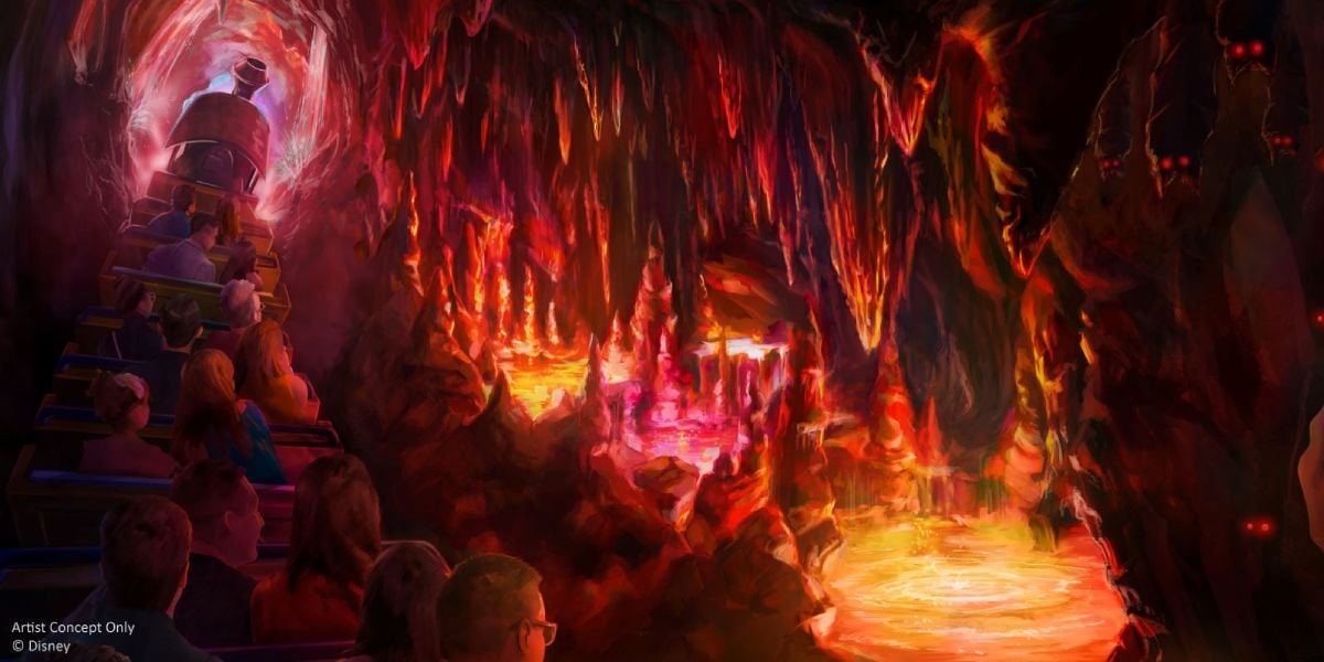 A group of people in a mine train ride through Big Thunder Mountain, racing past glowing stalactites and molten lava, illuminated by vibrant orange, pink, and red lights in a Wild Return adventure.