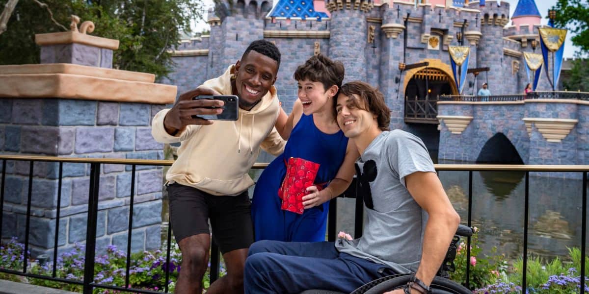 Three guests at Disneyland and one of them is in a wheelchair